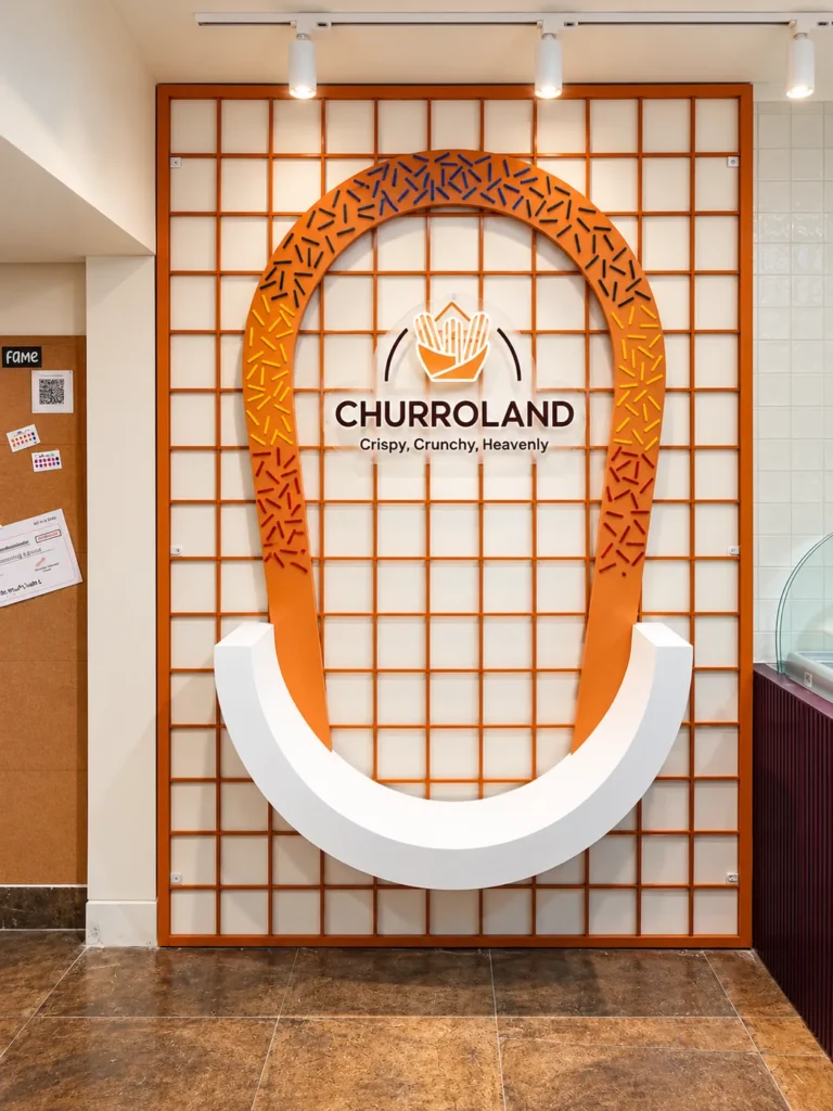 Giant sprinkle churro loop installation with the Churroland logo at the Koramangala outlet