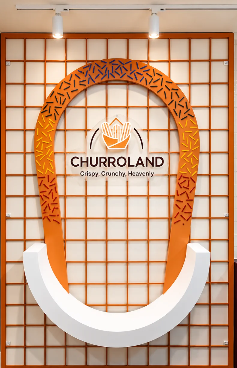 The giant churro loop wall with the Churroland logo at our Koramangala flagship
