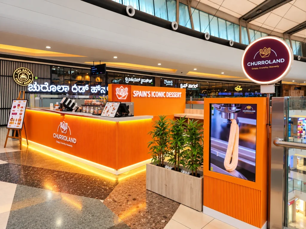 Churroland kiosk with "Spain's Iconic Dessert" sign at Mantri Square Mall, Malleshwaram